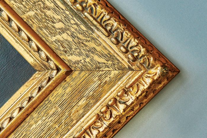 Image of the edge of a large gold picture frame
