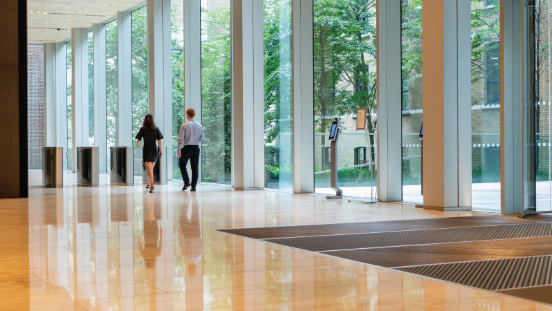 Two colleagues walking through reception