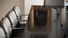Meeting table reflecting golden painting from the wall