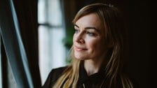 Middle aged woman looking away from the camera