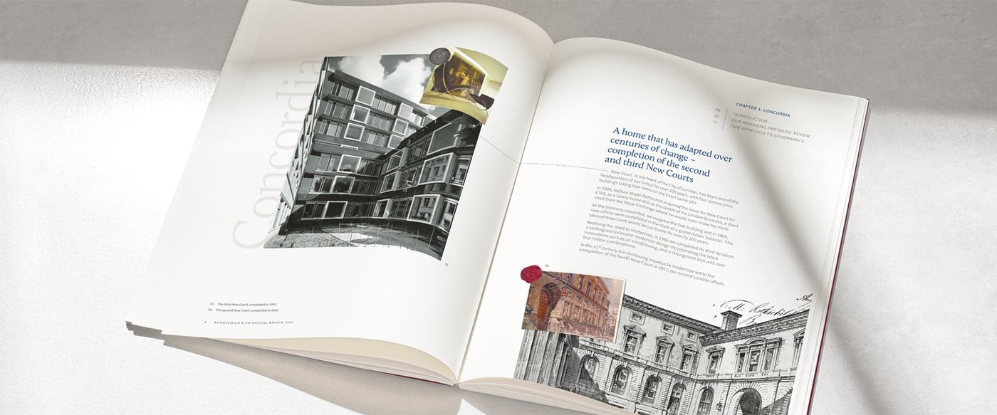 A photograph of our Annual Review brochure open across a double spread on a marble table