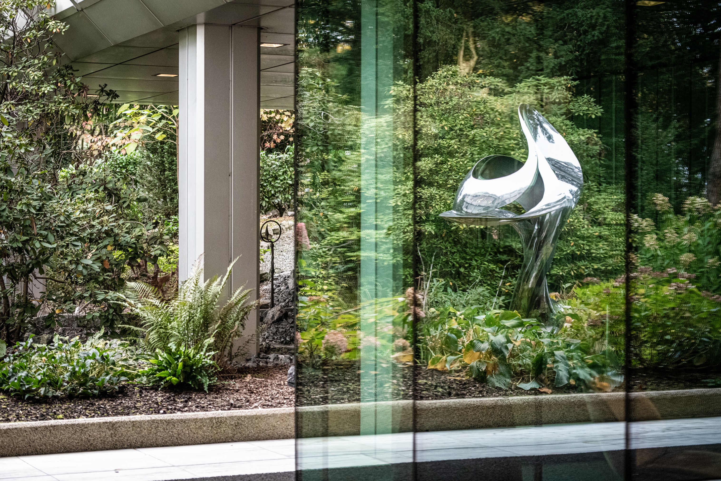 Courtyard of Rothschild & Co's Zurich office, with green plants and a metal sculpture