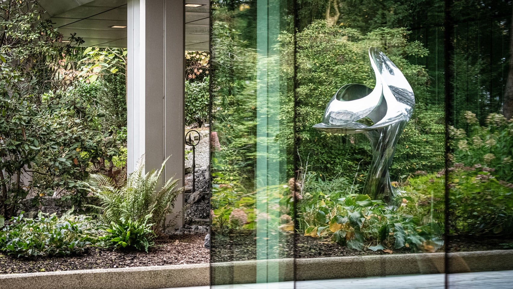 Courtyard of Rothschild & Co's Zurich office, with green plants and a metal sculpture