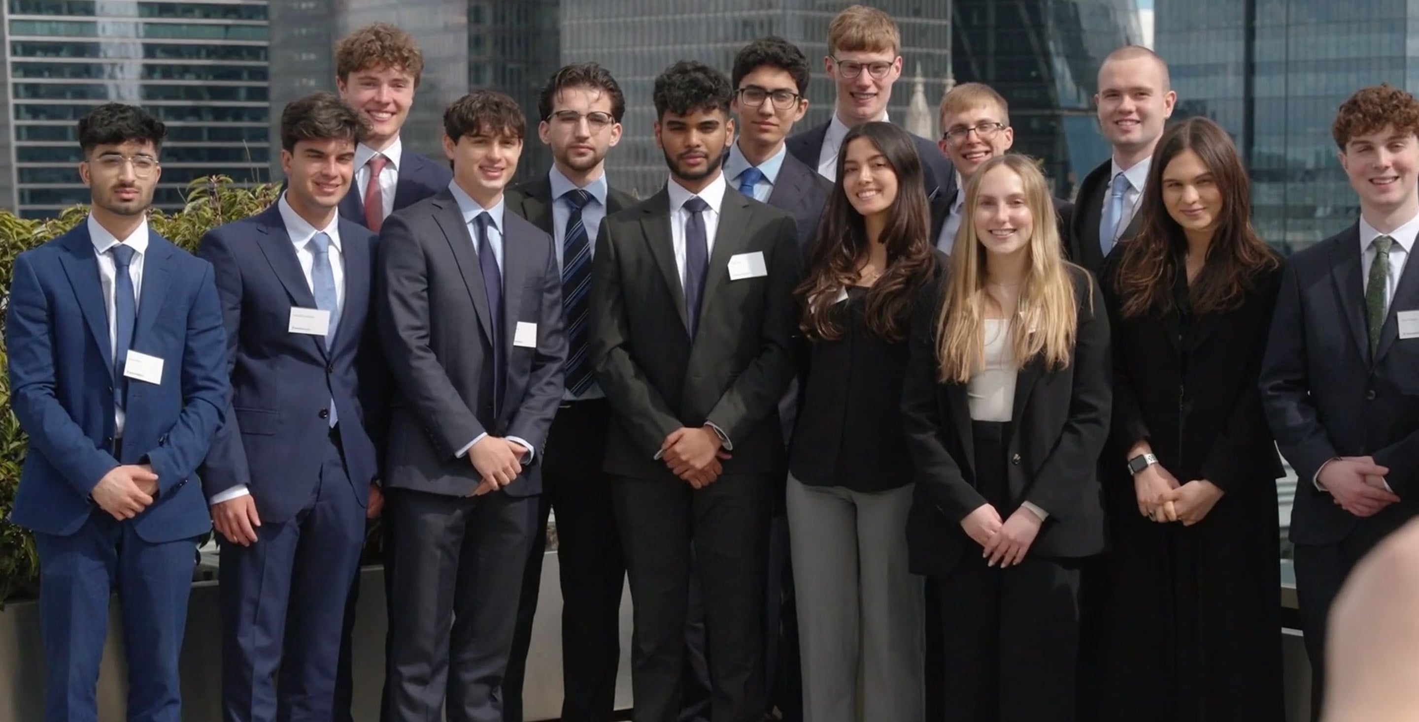 Students posing for a photograph with a suit and tie