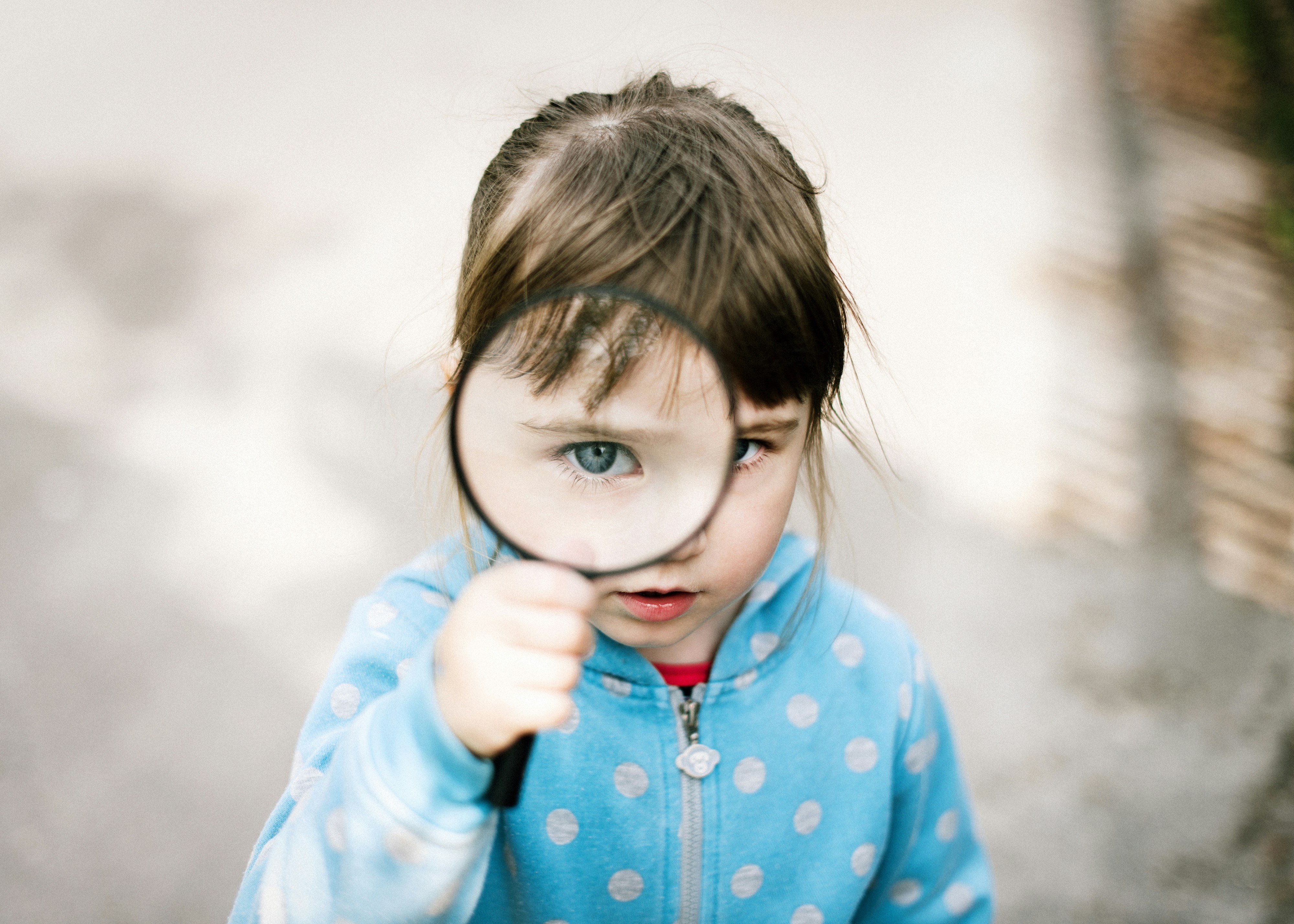 girl holding magnifying glass
