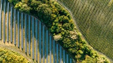 aerial view of fileds with solar panels