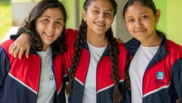 Three school girls from a Guatemala college smiling