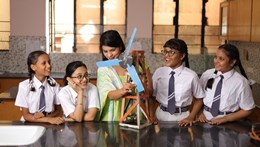 Young women learning about wind turbines