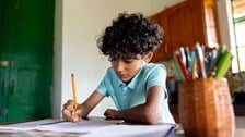 Boy drawing at desk