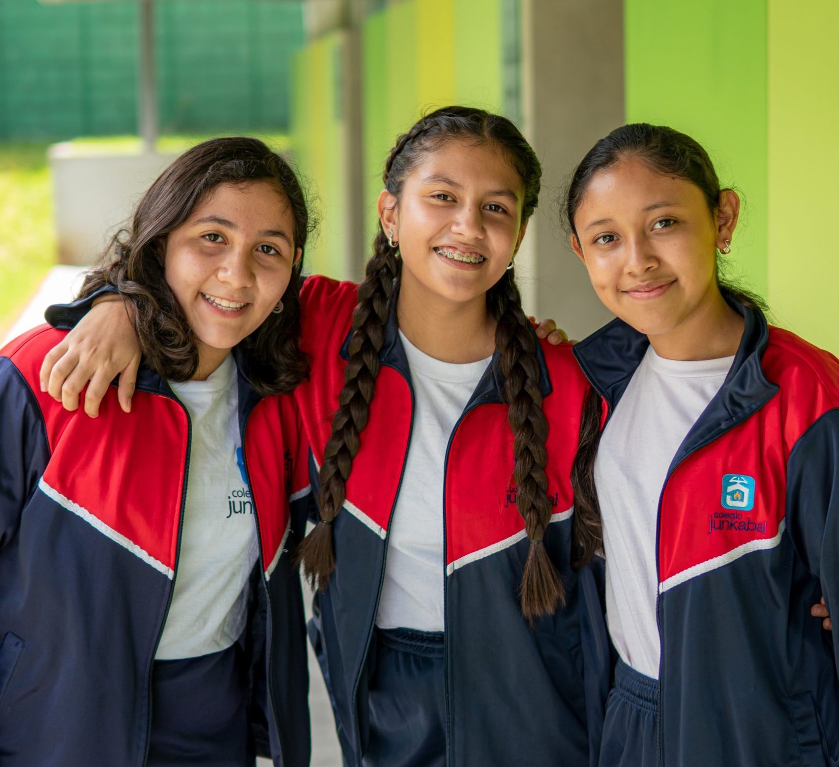 Three school girls from a Guatemala college smiling