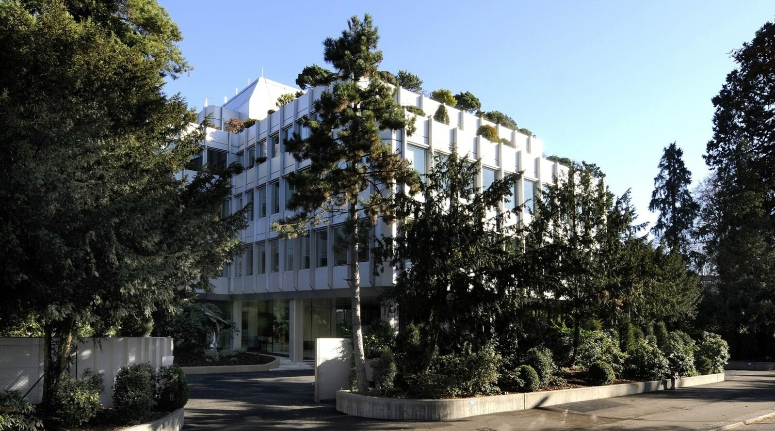 Rothschild & Co's Zurich office, a white building with trees around it