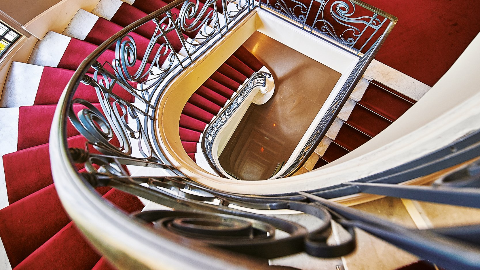 Staircase from above with red carpet