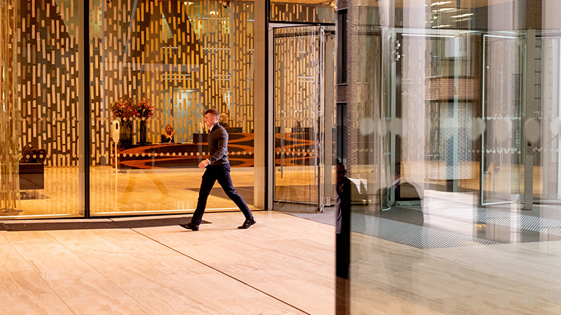 Person walking past Rothschild & Co's main entrance