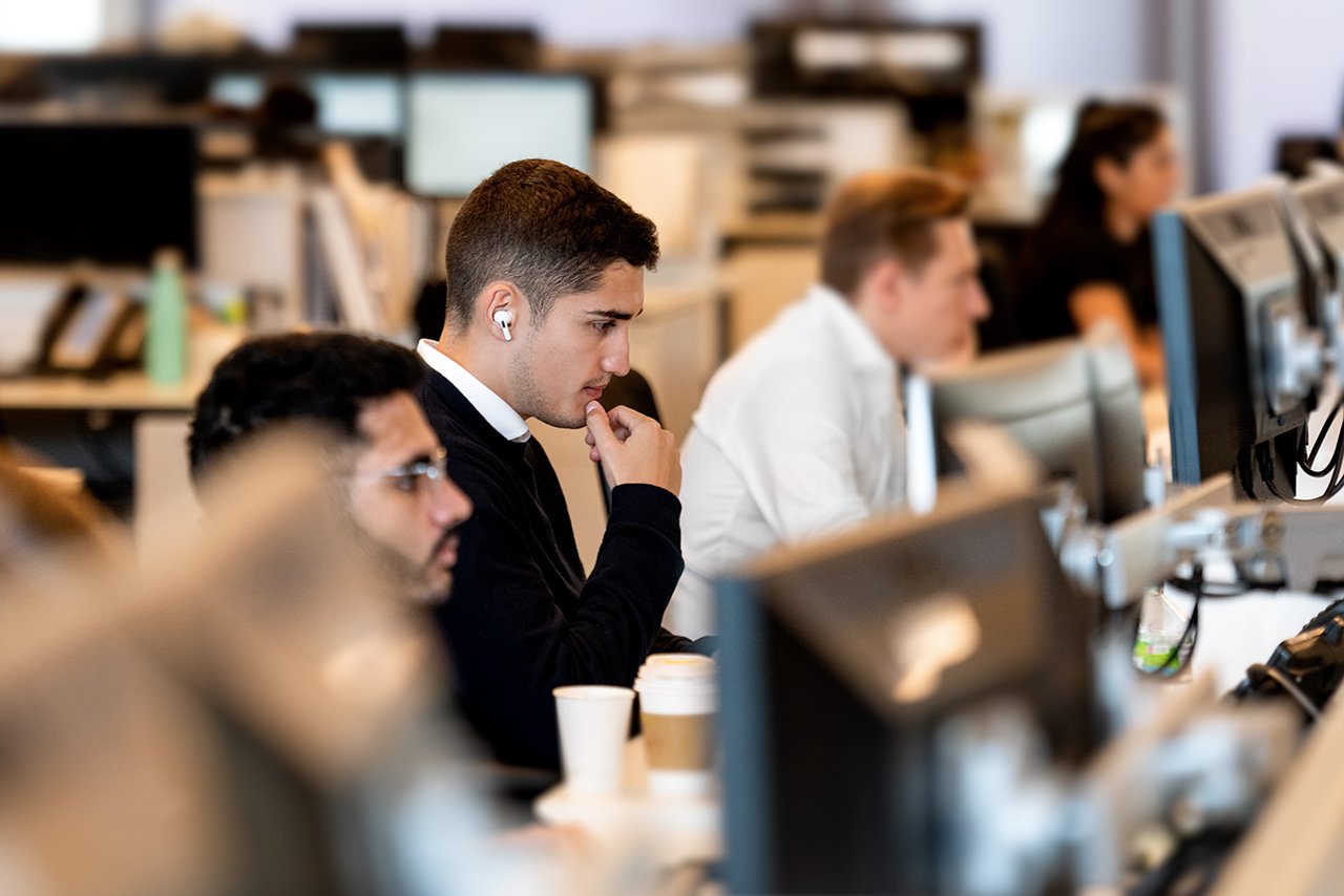 three people busy at work on their computers