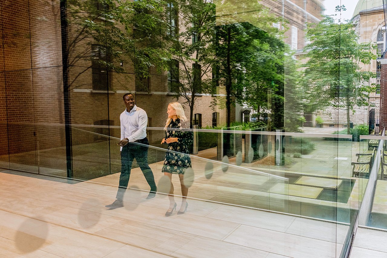 Two colleagues walking through the lobby