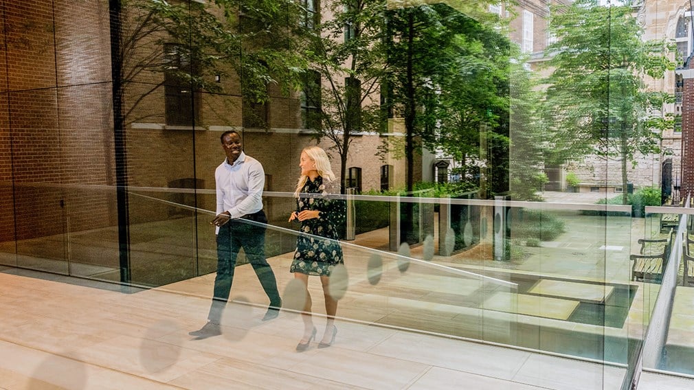 Two colleagues walking through the lobby