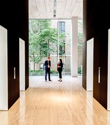 Two people having a discussion by the lobby lifts