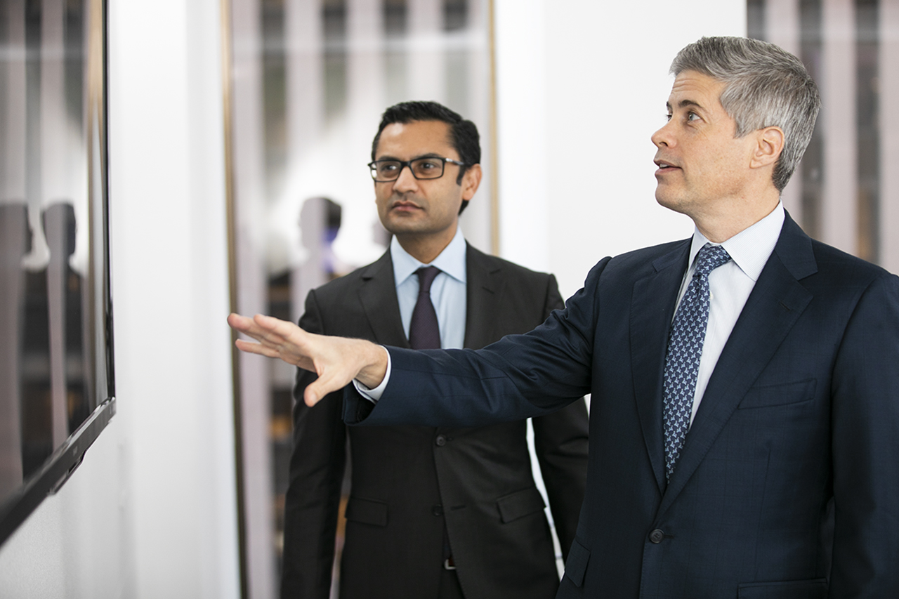 Two people looking at a TV monitor