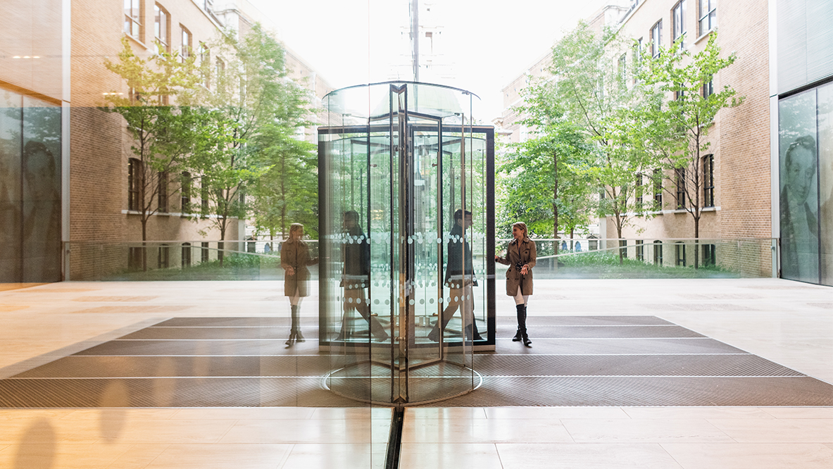 People walking into an office building in London