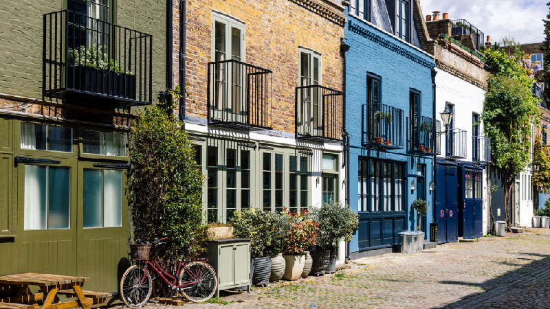 A row of different coloured, detached house in Notting Hill.