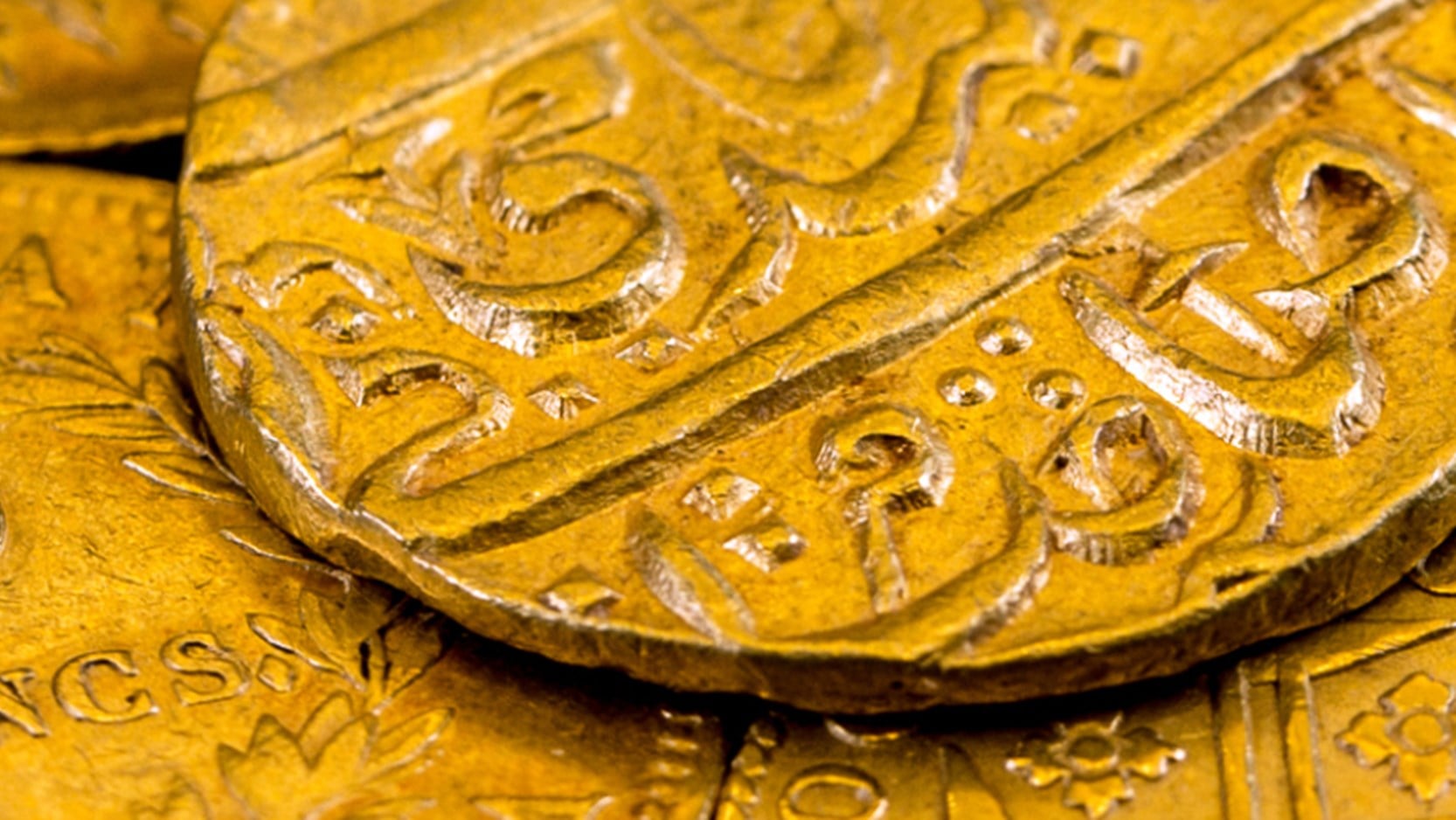 Detail of a Moghal Empire Mohur gold coin dating from 1806, from a case of fifteen gold and silver coins collected from around the world to commemorate the ‘Waterloo’ commission undertaken by Nathan Mayer Rothschild (1777-1836) and his brothers. Nathan's London banking House, N M Rothschild, dealt in bullion and foreign exchange, and his business successes earned him the contract from the British Government to supply Wellington's troops with gold coin in 1814 and 1815, leading up to the Battle of Waterloo. To fulfil the contract, Nathan and his brothers successfully bought up gold bullion and coins from all over Europe and beyond.