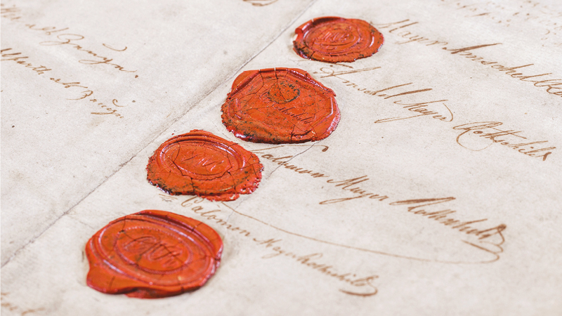Close up photo of wax stamps on parchment paper