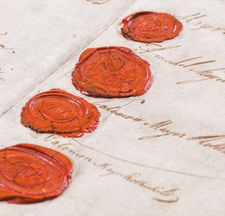 Close up photo of wax stamps on parchment paper