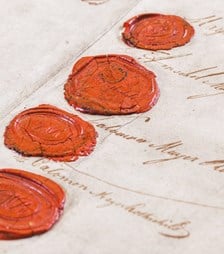 Close up photo of wax stamps on parchment paper