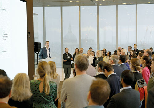 Image of people looking at the speaker on stage of a recent 3-Space event