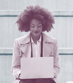 Image of a lady working on a laptop