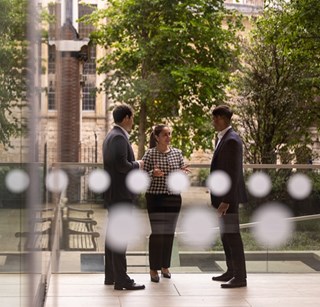Two people meeting outside of the Rothschild & Co New Court London office