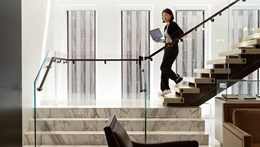 Image of a lady walking down some stairs inside the Rothschild offices