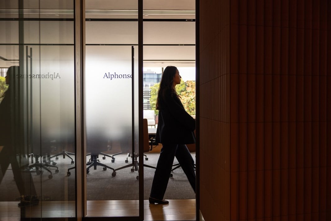 Image of a lady walking down an aisle inside the Rothschild offices