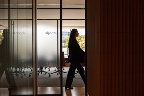 Image of a lady walking down an aisle inside the Rothschild offices