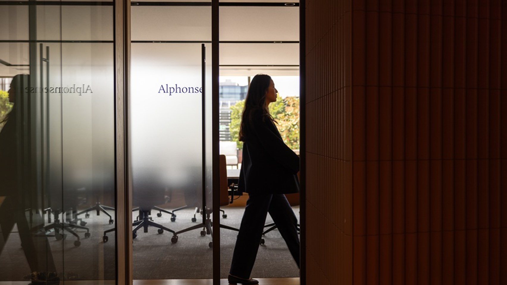 Image of a lady walking down an aisle inside the Rothschild offices