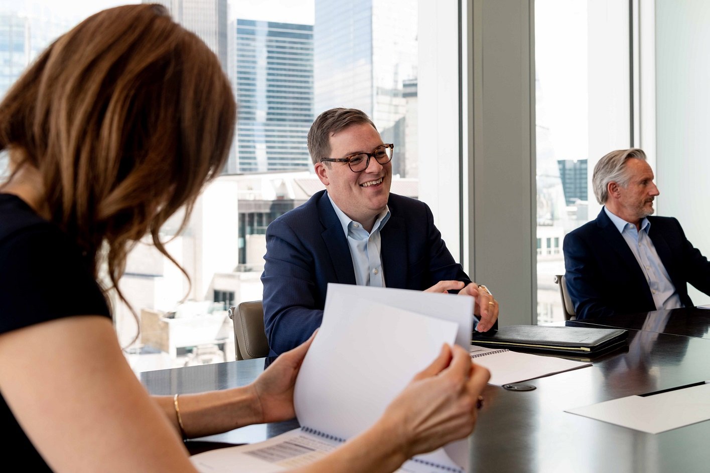 Man laughing during client meeting