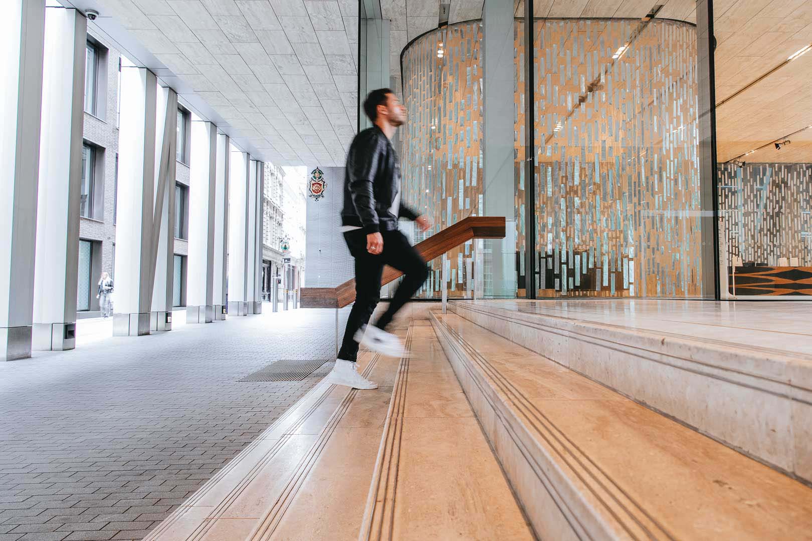 Man walking up the stairs of Rothschild & Co New Court office