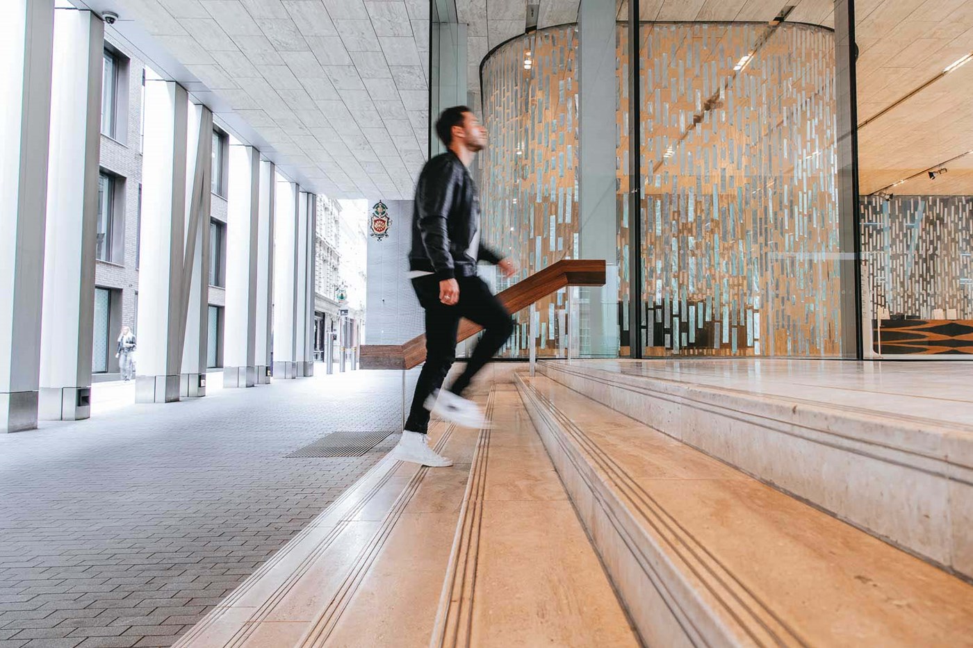 Man walking up the stairs of Rothschild & Co New Court office