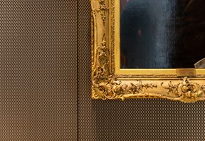 Photo of a dark oil painting with bright gold frame