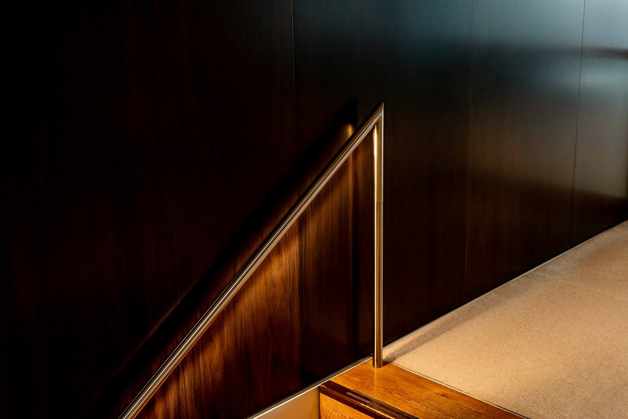 Handrail leading up one flight of stairs in an office