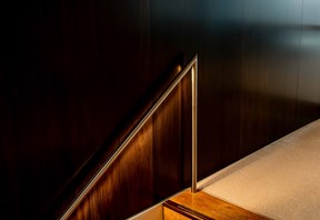 Handrail leading up one flight of stairs in an office