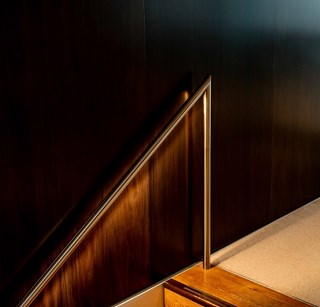 Handrail leading up one flight of stairs in an office