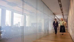 Image of two people having a conversation as they walk through the London Rothschild office