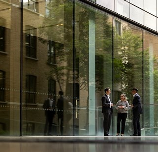 Three people talking outside of the Rothschild & Co New Court office