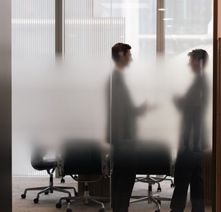 Two people meeting in one of the meeting rooms at Rothschild & Co's New Court office