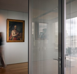 Image of someone walking down the hallway of the Rothschild & Co offices