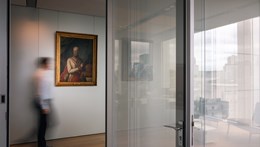 Image of a man walking through the Rothschild office in front of a family oil painting