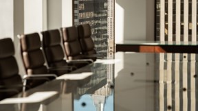 Image of some chairs tucked under a table in one of the meeting rooms at the Rothschild & Co New York office
