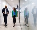 Male and female colleague walking in the offices of Rothschild & Co Redburn