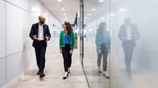 Male and female colleague walking in the offices of Rothschild & Co Redburn